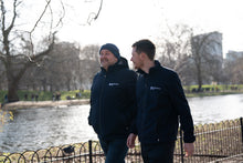 Parkinson's UK unisex sports soft shell jacket in navy made from 63 recycled bottles.